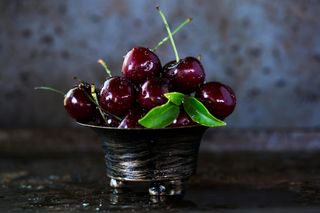 Red cherries in a stainless steel bowl